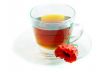 Poppy in glass cup on white table 