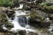 Small mountain waterfall among the rocks. 