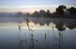 Foggy morning landscape in the autumn park near the lake. Vintag