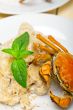 Italian gnocchi with seafood sauce with crab and basil