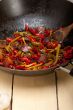 fried chili pepper and vegetable on a wok pan