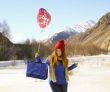 cheerful girl with a balloon and a package 