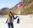 Happy girl with a balloon and a package 