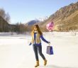 Happy girl with a balloon and a package 