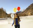Funny girl with balloons on the hair 