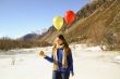 Funny girl with oranges and balloons on the hair 