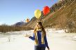 Funny girl with oranges and balloons on the hair 