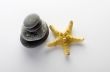 pile of stones and sea star closeup on white background