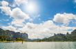 Sun over lake and mountain