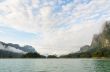Sky above the mountains and green lake