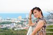 Woman poses on a high point overlooking the city.