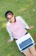 Cute girl is happy with notebook on grass