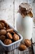 meringue almond cookies in a bowl and bottle of milk 