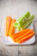 bundle of fresh green celery stems and carrot