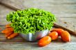 lettuce salad in metal bowl, tomatoes and carrots 