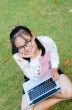 Lovely girl with a laptop on the grass
