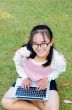 Lovely girl with a laptop on the grass