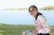 Young girl with laptop on the grass