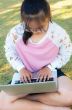 Girl working with laptop on grass