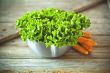 lettuce salad in metal bowl and carrots 