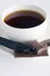 Cup of hot tea with dark chocolate