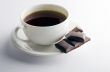 Cup of hot tea with dark chocolate
