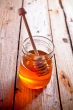 full honey pot and honey stick 
