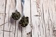 two spoons of dried green tea leaves 
