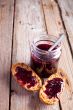 black currant jam in glass jar and crackers 