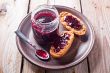 black currant jam in glass jar and crackers