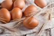  fresh brown eggs and wheat ears 