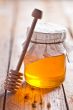 full honey pot and honey stick 