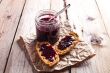 black currant jam in glass jar and crackers