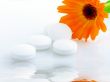 Flower marigold medical with pills over white background