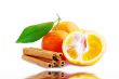 Tangerine with cinnamon on a white background