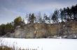Panorama of an abandoned stone pit in winter 