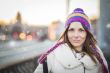 Positive girl with colorfull hat in winter city