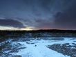 Snow covered stone quarry in the winter with all the tools and b