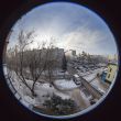 A view from the window on the winter city and houses  by fisheye view