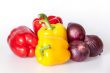Large red and yellow paprikas and red onions