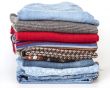 Woolen jumpers of various colors and blue jeans
