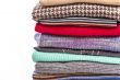 Pile of woolen jumpers of various colors and textures