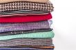 Pile of woolen jumpers of various colors and textures