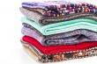 Pile of woolen jumpers of various colors and textures