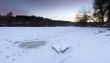 clear river ice in cold winter morning under sunbeams