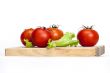 Red juicy tomatoes and lettuce leaves