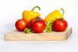 Large paprika of yellow color and red tomatoes