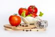 Red juicy tomatoes, lettuce leaves and black pepper