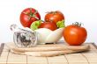 Red juicy tomatoes, lettuce leaves and black pepper