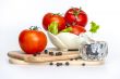 Red juicy tomatoes, lettuce leaves and black pepper